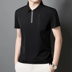 Detailed view of black polo shirt featuring a quarter-zip collar and hidden chest pocket