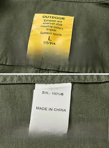 Detail of internal clothing label showing 100% cotton material and outdoor textile tag