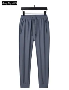 Detail view of grey ice silk joggers with drawstring waist and secure zipper pockets