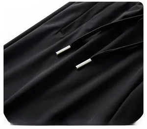 Close-up of black drawstring with silver metallic tips on ice silk sports trousers