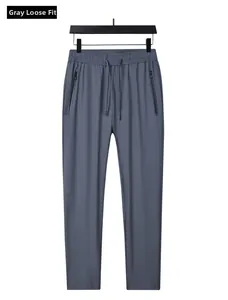 Detail of grey ice silk men's pants featuring zipper pockets and adjustable drawstring