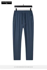 Detail of men's ice silk trousers with gray-blue elastic waist and zipper pockets