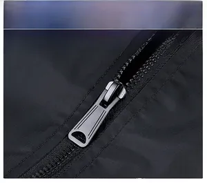 Close-up of durable gunmetal zipper on black water-resistant nylon bomber jacket