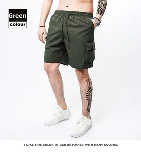 Detail of olive green cargo shorts featuring drawstring waist and large side pocket