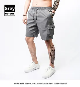 Detail view of gray men's cargo shorts featuring drawstring waist and large side pockets
