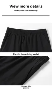 Detail view of elastic waistband with adjustable drawstring and side pockets on black shorts