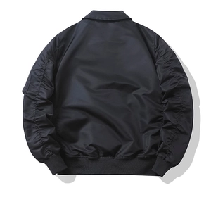 Rear view of black bomber jacket featuring ruched sleeves and ribbed cuffs on white background