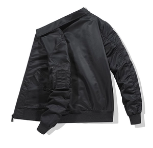 Detail of black pilot bomber jacket showing sleeve zipper pocket and satin texture