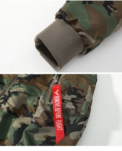 Detail of woodland camo bomber jacket featuring ribbed cuffs and utility arm pocket