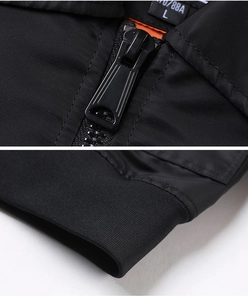 Detail view of black flight jacket featuring metal zipper, collar tag, and ribbed cuffs