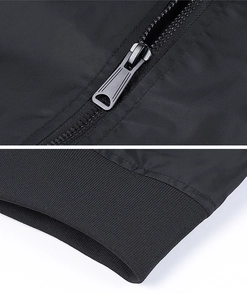 Detail of matte black metal zipper and elastic ribbed cuffs on MA1 pilot jacket