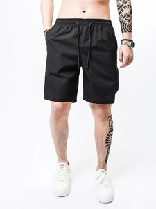 Men's black casual cargo shorts with drawstring waist and functional side flap pockets