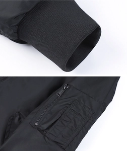 Detail of MA-1 bomber jacket featuring ribbed cuffs and a functional zippered sleeve pocket