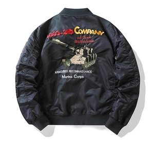 Detailed military-style tank embroidery on the back of a black nylon bomber jacket