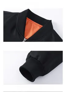 Detail of black bomber jacket featuring orange lining and ribbed knit collar and cuffs