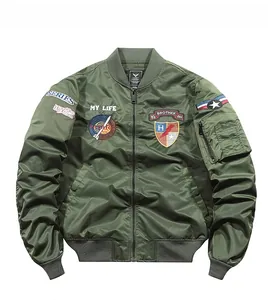 Detailed view of military green bomber jacket with embroidered tactical patches and arm pocket