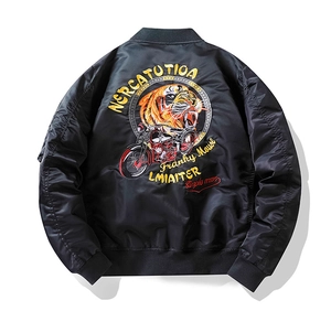Detailed embroidery of tiger and vintage motorcycle on back of black bomber jacket