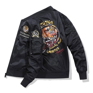 Detailed tiger and vintage motorcycle embroidery on the back of a black bomber jacket