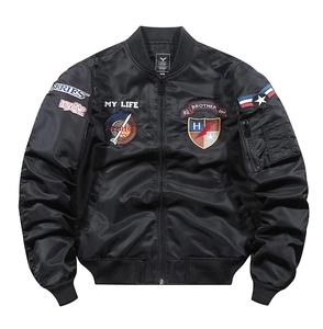 Detailed view of black bomber jacket with intricate chest embroidery and utility sleeve pocket