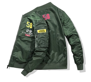 Detail of army green bomber jacket with embroidery patches and ribbed collar