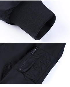 Detail of ribbed knit cuffs and arm zipper pocket on black bomber flight jacket