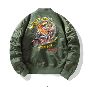 Detailed tiger riding motorcycle embroidery on the back of a green pilot bomber jacket
