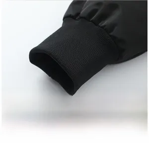 Detailed macro view of high-density windproof black fabric and elastic ribbed cuffs