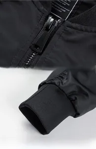 Detail of the black flight jacket with metallic zipper and ribbed knit elastic cuffs