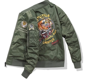 Detail of army green bomber jacket featuring tiger embroidery and utility sleeve pocket