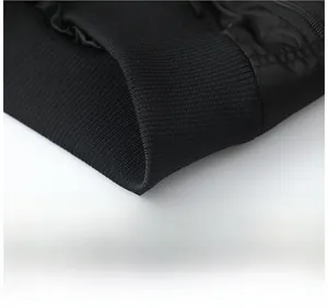 Close-up of the high-density ribbed knit hem on a black MA1 pilot flight jacket