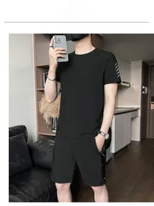 Selfie view of men's black quick-dry sports set with dotted sleeve detail and shorts