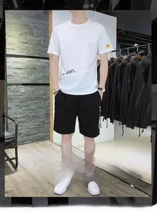 Detail of white ice silk t-shirt and black shorts with graphic prints for summer men's outfit