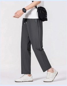Detail of dark grey quick-dry pants with adjustable drawstrings and waterproof zipper pockets