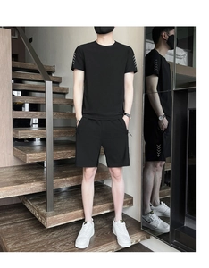 Detail view showing white arrow prints on the short sleeve and shorts of men's sports set
