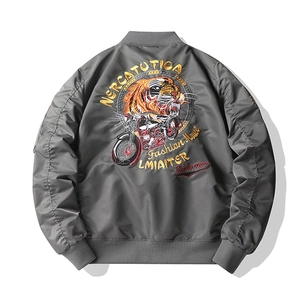 Detailed embroidery of a tiger and vintage motorcycle on a grey bomber jacket