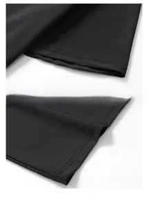 Detail view of reinforced sleeve cuffs and double-stitched hem on black mesh sports shirt