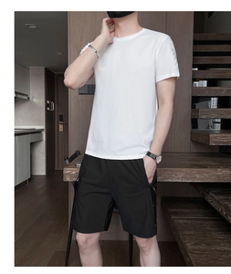 Detailed shot of white crew neck t-shirt with printed sleeves and black casual shorts