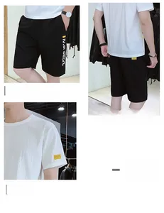Close-up of white ice silk t-shirt with yellow tag and black shorts with side lettering