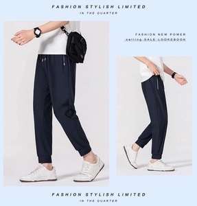 Detail view of navy blue ice silk trousers featuring side silver zipper pockets and drawstring