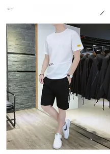 Detail view of white ice silk t-shirt with SEON lettering and black casual sports shorts