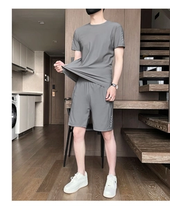 Elastic detail of men's quick-dry sports set with reflective dots on grey fabric