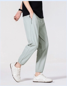 Close-up of lightweight ice silk men's pants showing hidden zipper pocket and joggers cuff