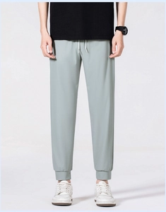 Detail of sage green men's quick-dry pants featuring elastic drawstring waist and ribbed cuffs