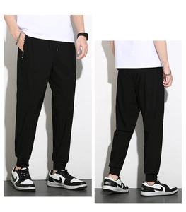 Detail of men's ice silk joggers featuring elastic drawstring waist and zipper pockets