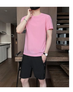 Detail view of men's pink quick-dry t-shirt and black shorts sports set with zipper pockets