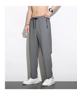 Detail of grey quick-dry pants featuring elastic drawstring waist and side zipper pocket