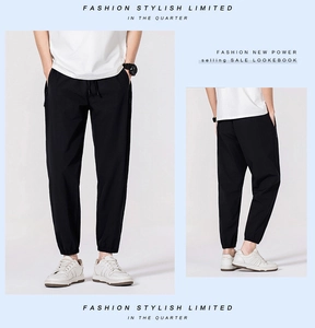Detail view of men's black quick-dry jogger pants with elastic drawstring waist