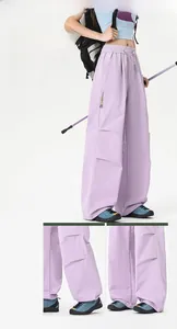 Detail view of light purple waterproof outdoor cargo pants with drawstring hem and side pocket