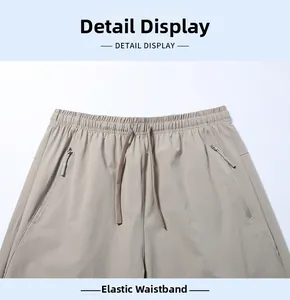 Close-up of men's ice silk trousers featuring elastic waist with drawstring and zip pockets