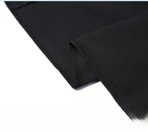 Gros plan sur les coutures renforcées d'un pantalon en soie glacée noire respirante